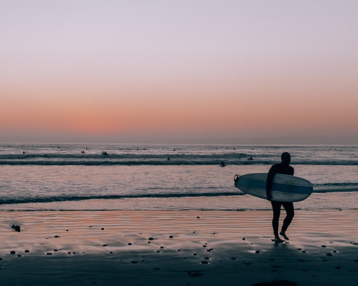 sunset at Tourmaline in San Diego with surfer, 10 things to know before moving to San Diego, Living in San Diego real estate