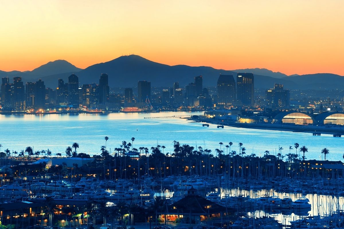 San Diego and the harbor at dusk, How much do you need to buy a house in San Diego, Living in San Diego real estate feature img